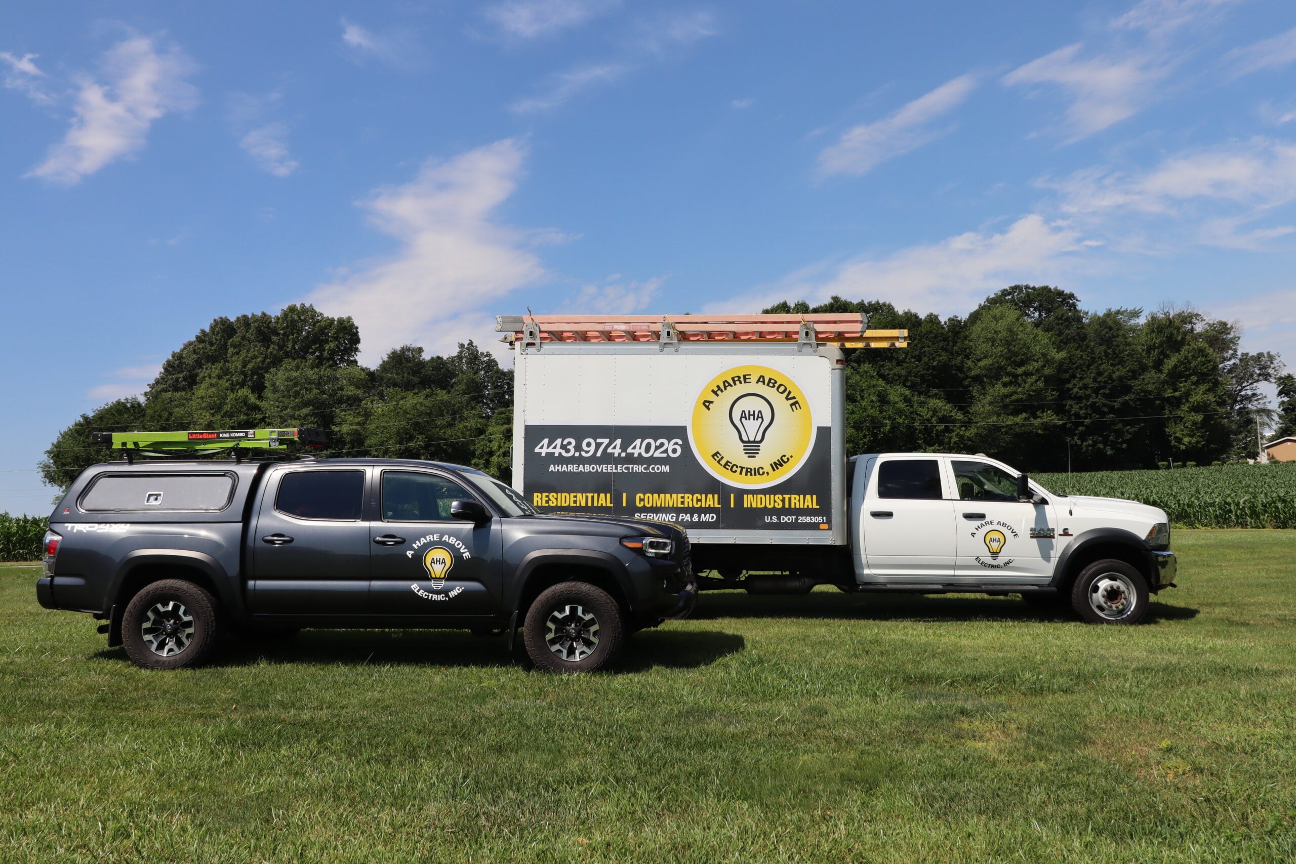 A Hare Above Electric service trucks parked in a field